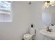 Modern powder room with a pedestal sink, sleek faucet, and soft lighting at 13708 Daffodil Pt, Parker, CO 80134