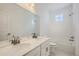 Bathroom with double sink vanity and a tiled shower-tub combo, offering a functional design at 13708 Daffodil Pt, Parker, CO 80134