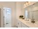 Elegant bathroom featuring double sinks, ample counter space, and a well-lit mirror at 13708 Daffodil Pt, Parker, CO 80134