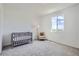 Cozy bedroom with a crib, chair, and a window offering a scenic view at 13708 Daffodil Pt, Parker, CO 80134