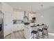 Bright, white kitchen with stainless steel appliances, a granite island and stylish pendant lighting at 13708 Daffodil Pt, Parker, CO 80134