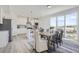 Open concept kitchen with island seating flows seamlessly into a dining area with scenic views at 13708 Daffodil Pt, Parker, CO 80134