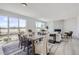 Bright and open living space with large windows, dining area, fireplace, and wood-style flooring at 13708 Daffodil Pt, Parker, CO 80134