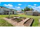 Landscaped backyard with raised garden beds and shed at 6653 N Knox Ct, Denver, CO 80221