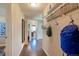 Home hallway with wood floors, mirror, and storage at 6653 N Knox Ct, Denver, CO 80221