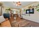 Open living room with hardwood floors and a view of the kitchen at 6653 N Knox Ct, Denver, CO 80221