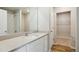Bathroom featuring a single sink vanity, large mirror, and shower with white tile at 48229 Shetland Dr, Bennett, CO 80102