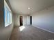 This bedroom features neutral walls, carpet floors, with natural light streaming from a large window at 48229 Shetland Dr, Bennett, CO 80102