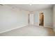 Spacious bedroom with neutral carpeting and doorways leading to the ensuite bathroom and walk-in closet at 48229 Shetland Dr, Bennett, CO 80102