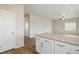 Kitchen island featuring gray counters, white cabinets, stainless steel hardware, and hardwood-style floors at 48229 Shetland Dr, Bennett, CO 80102