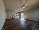 Bright, open living room with hardwood floors, recessed lights, and stainless steel appliances in the kitchen at 48229 Shetland Dr, Bennett, CO 80102
