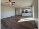 Open-concept living room with hardwood floors and recessed lighting next to a kitchen area at 48229 Shetland Dr, Bennett, CO 80102