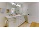 Bright bathroom with double vanity, quartz counters, gold hardware, and modern lighting fixtures at 1881 Mallard Dr # 1881, Superior, CO 80027