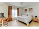 Bright bedroom featuring a ceiling fan, desk and an adjacent night stand at 1881 Mallard Dr # 1881, Superior, CO 80027