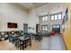 Spacious common area with high ceilings, TV, seating, and multiple tables at 1881 Mallard Dr # 1881, Superior, CO 80027