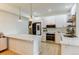 Bright kitchen featuring white cabinets, stainless steel appliances, and a large quartz countertop island at 1881 Mallard Dr # 1881, Superior, CO 80027