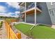 Backyard features a well-maintained lawn, patio, wood fence, and stairs to the upper balcony at 11000 Shining Star Cir, Parker, CO 80134