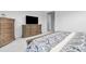 Cozy bedroom featuring a wooden dresser, patterned bedding, and soft carpeting for added comfort at 11000 Shining Star Cir, Parker, CO 80134