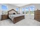 Sunlit bedroom with a luxurious bed frame, matching nightstands, and multiple windows offering scenic views at 11000 Shining Star Cir, Parker, CO 80134