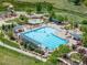 Aerial view of the community pool, showcasing a large pool, splash pad, lounging areas, and surrounding landscaping at 11000 Shining Star Cir, Parker, CO 80134