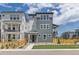 Attractive three-story home with blue siding and a charming wooden fence under a sunny, partly cloudy sky at 11000 Shining Star Cir, Parker, CO 80134