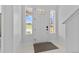 Bright foyer showcases a clean white front door flanked by side windows, creating an airy entrance at 11000 Shining Star Cir, Parker, CO 80134
