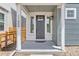 Inviting front porch featuring a modern gray door, stylish lighting, and decorative window accents at 11000 Shining Star Cir, Parker, CO 80134