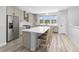 Bright kitchen features stainless steel appliances, a large island with seating, and a picturesque window view at 11000 Shining Star Cir, Parker, CO 80134