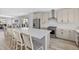 Modern kitchen with sleek countertops, stainless steel appliances, and a spacious center island with barstool seating at 11000 Shining Star Cir, Parker, CO 80134