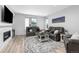 Comfortable living room with a cozy fireplace, plush sofas, and stylish decor, perfect for relaxation at 11000 Shining Star Cir, Parker, CO 80134