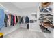 Organized walk-in closet with shelving for shoes and hanging racks for clothes, maximizing storage space at 11000 Shining Star Cir, Parker, CO 80134