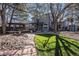Expansive backyard with lush turf, stone walkway, mature trees, and entertainment space at 14707 E Wagon Trail Dr, Aurora, CO 80015