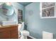 Modern bathroom with a unique sink, statement mirror and a window letting in natural light at 14707 E Wagon Trail Dr, Aurora, CO 80015