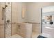 Barrier free shower design complete with hand rails, tile accent wall and a bench at 14707 E Wagon Trail Dr, Aurora, CO 80015