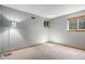 Empty bedroom features a large closet, two windows with blinds, and light gray walls at 14707 E Wagon Trail Dr, Aurora, CO 80015