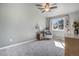 Spacious bedroom with carpet flooring, a side table, sitting chair, and a large window with a view at 14707 E Wagon Trail Dr, Aurora, CO 80015
