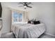 Bright bedroom with a large window, plush bedding, and neutral color palette at 14707 E Wagon Trail Dr, Aurora, CO 80015