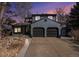 Beautiful two-story home featuring a two-car garage and a well-maintained front yard at sunset at 14707 E Wagon Trail Dr, Aurora, CO 80015