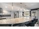 Open kitchen with granite island, stainless steel refrigerator, and pendant lighting at 14707 E Wagon Trail Dr, Aurora, CO 80015