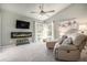 Cozy living room with vaulted ceilings, fireplace, and lots of natural light from the windows at 14707 E Wagon Trail Dr, Aurora, CO 80015