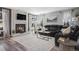 Cozy living room with a fireplace, large windows, and comfortable leather seating at 14707 E Wagon Trail Dr, Aurora, CO 80015