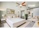 Bright main bedroom with a white bed, a fluffy rug, and open layout with easy access to the bathroom and closet at 14707 E Wagon Trail Dr, Aurora, CO 80015