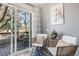 Cozy sitting area with a sliding glass door leading to the deck and neutral decor at 14707 E Wagon Trail Dr, Aurora, CO 80015