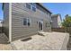 Home exterior featuring a paved patio and wood-paneled siding under blue skies at 1138 W 84Th Pl, Denver, CO 80260