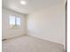 Bright, carpeted bedroom featuring a large window with a pleasant outdoor view at 1138 W 84Th Pl, Denver, CO 80260