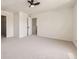 Large bedroom with neutral carpet, ceiling fan, and walk-in closet at 1138 W 84Th Pl, Denver, CO 80260