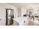 Bright kitchen with stainless steel appliances, white cabinetry, and a center island at 1138 W 84Th Pl, Denver, CO 80260