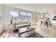 Bright, open-concept living room with hardwood floors and an adjacent kitchen area at 1138 W 84Th Pl, Denver, CO 80260