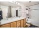 Bright bathroom with a double sink vanity, large mirror, and combined shower and tub at 1555 California St # 304, Denver, CO 80202