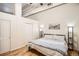 Comfortable bedroom features a large bed, wood floors, and modern lighting at 1555 California St # 304, Denver, CO 80202